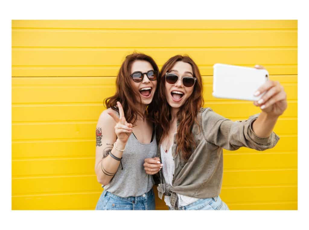two girls selfie representing how to make money selling photos of yourself