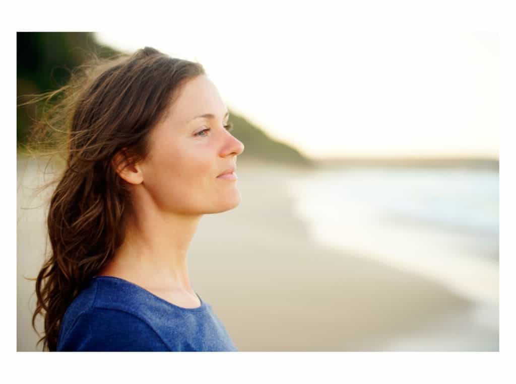 woman standing at peace representing signs of manifestation 